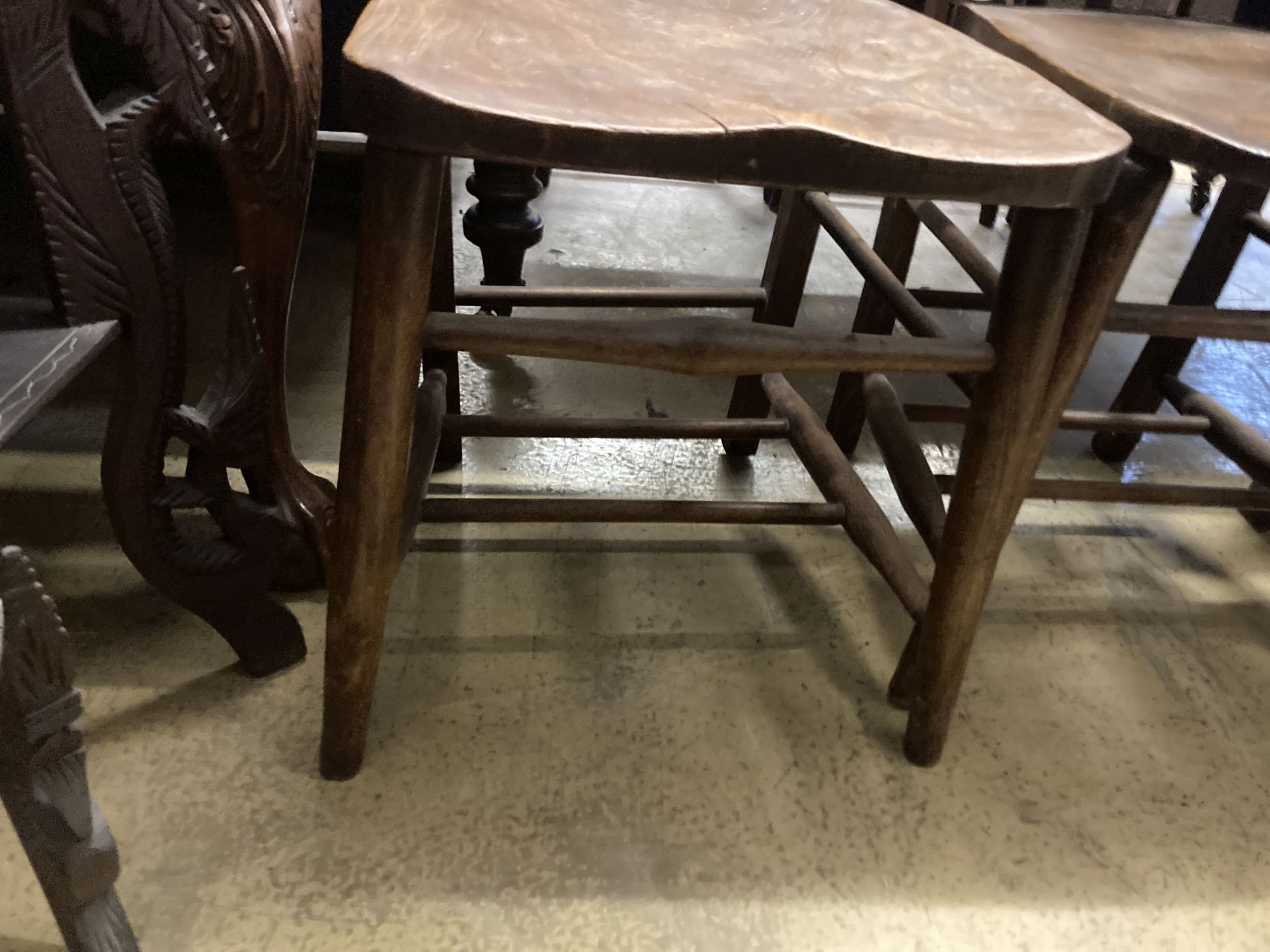 A set of four late Victorian elm and beech chapel chairs.